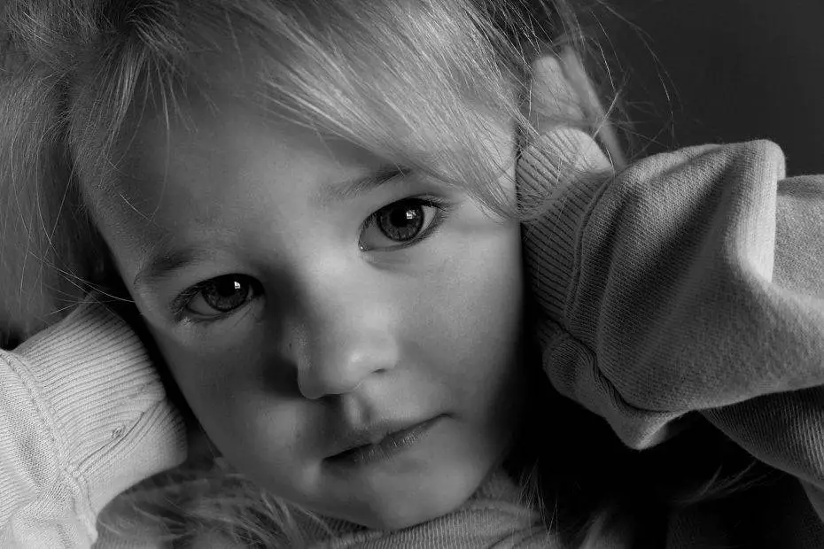 a black and white photo of a little girl